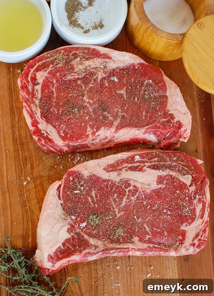 Pan-Seared Ribeye with Goat Cheese and Sun-dried Tomatoes on cutting board