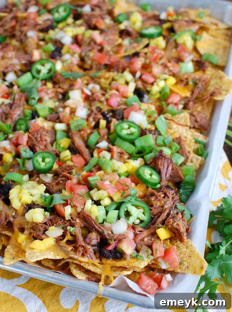 Loaded Beef Nachos on a Sheet Pan, ready to serve for a party or game day