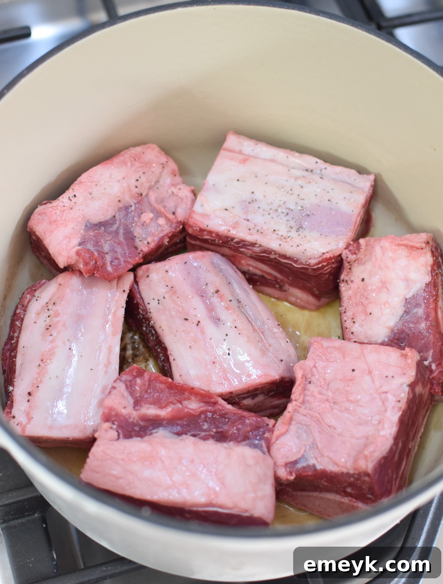 Rich & Savory Italian Slow Cooker Short Ribs 3 Searing beef short ribs in a Dutch oven before slow cooking.