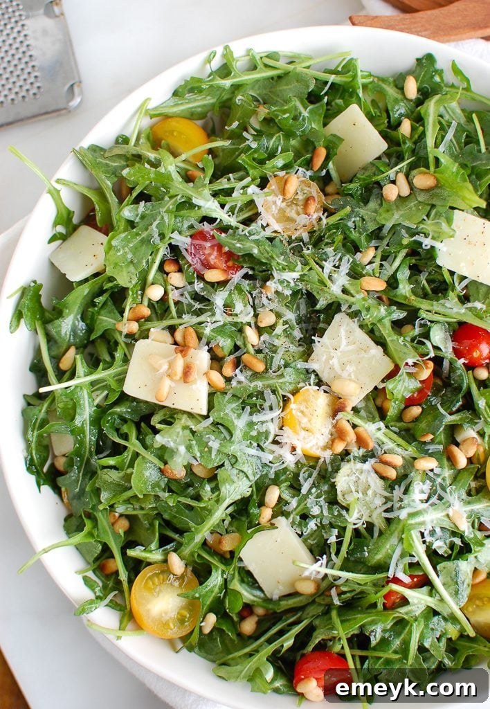 Lemon Arugula Salad with Pine Nuts and Parmesan Cheese, close-up shot revealing texture.
