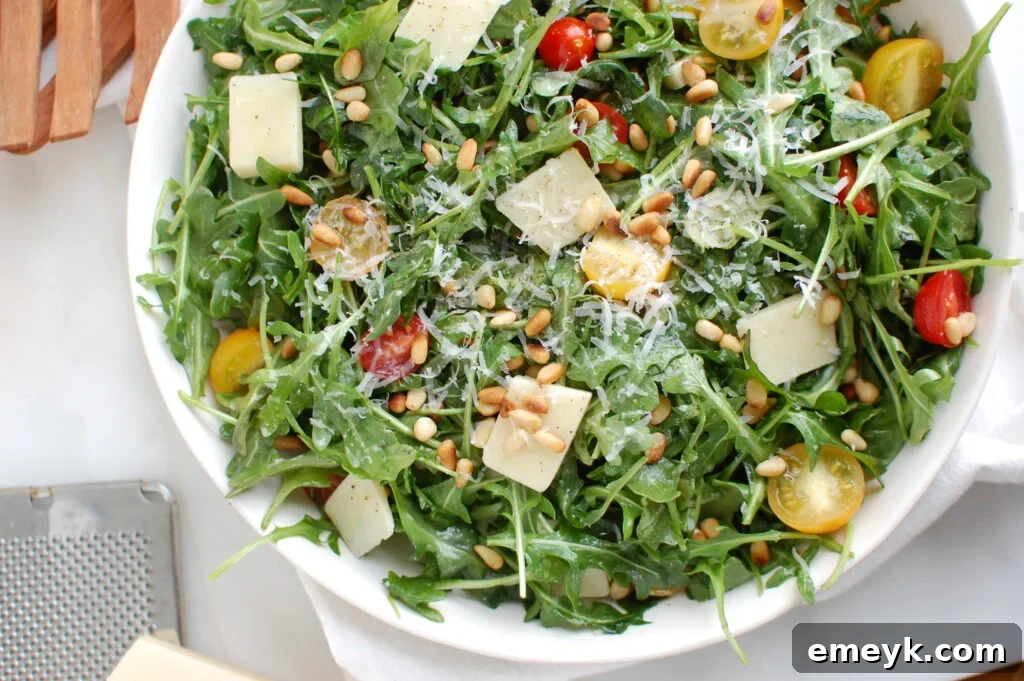 Lemon Arugula Salad with Pine Nuts in a serving bowl, garnished.