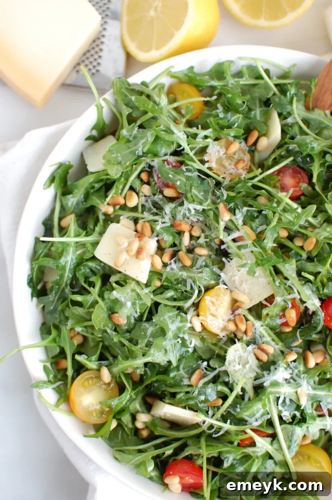 Overhead shot of Lemon Arugula Salad with Pine Nuts in a bowl.