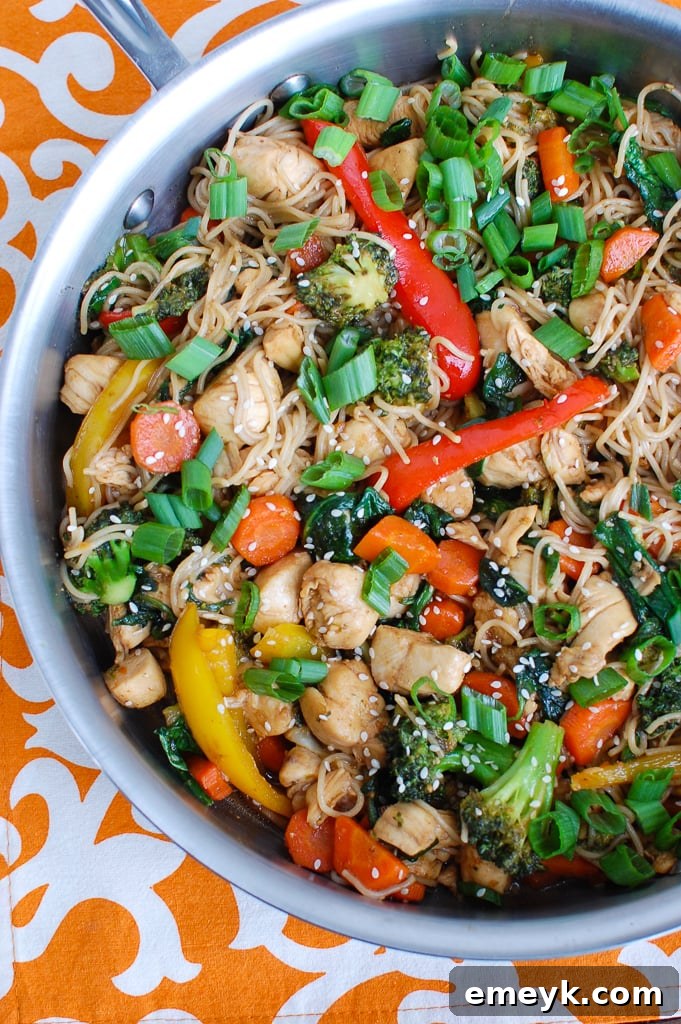 Easy Chicken Ramen Noodle Stir Fry cooking in a large skillet