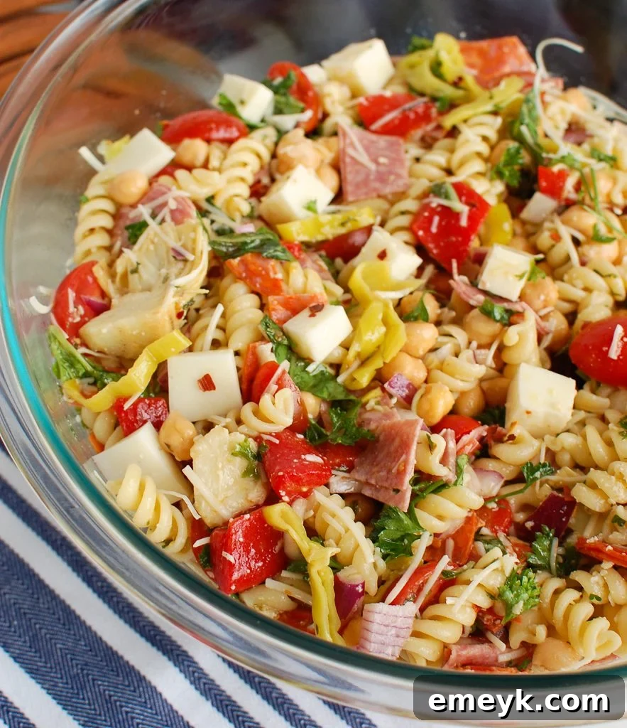 Italian Pasta Salad presented in a clear glass serving bowl, showcasing its colorful ingredients and homemade dressing