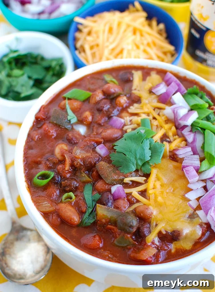Hearty Slow Cooker Vegetarian Chili served in a white bowl, garnished with fresh cilantro and sour cream
