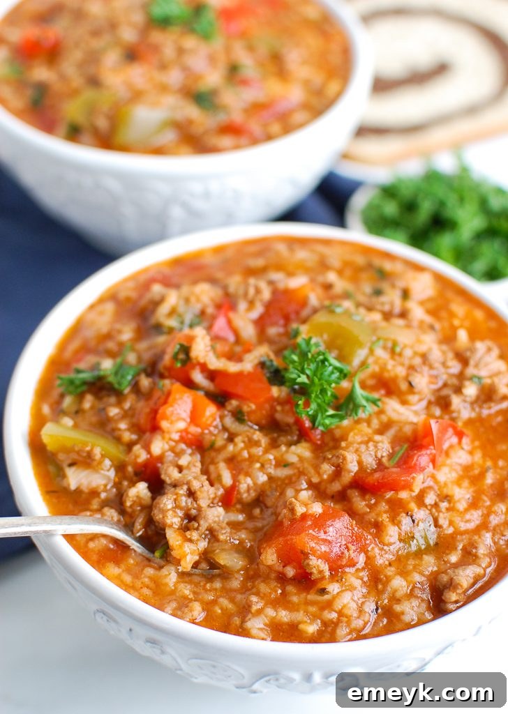 Instant Pot Stuffed Pepper Soup in a white bowl, garnished with fresh parsley.
