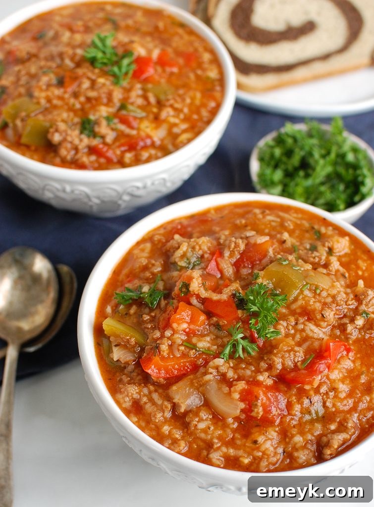 Two bowls of Instant Pot Stuffed Pepper Soup with a spoon