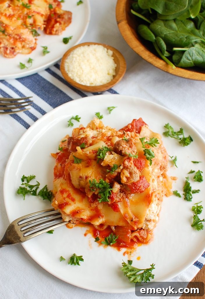 Slow Cooker Lasagna with Fork ready to serve, showing gooey cheese and rich sauce.