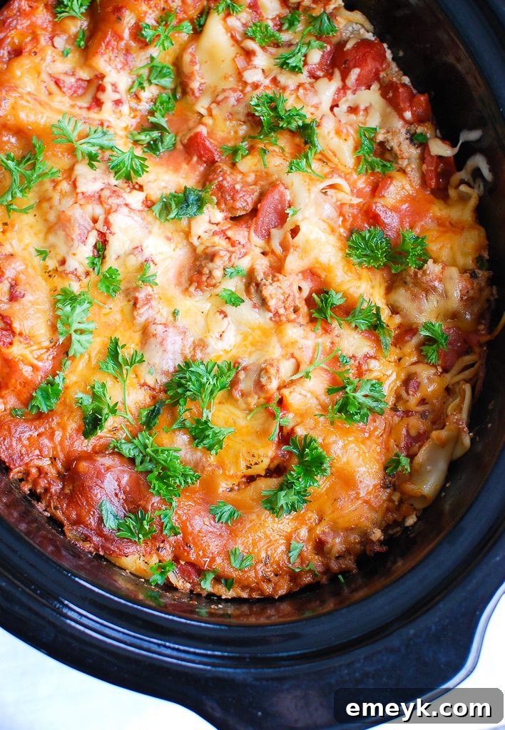 Assorted ingredients for Slow Cooker Lasagna displayed on a wooden board.