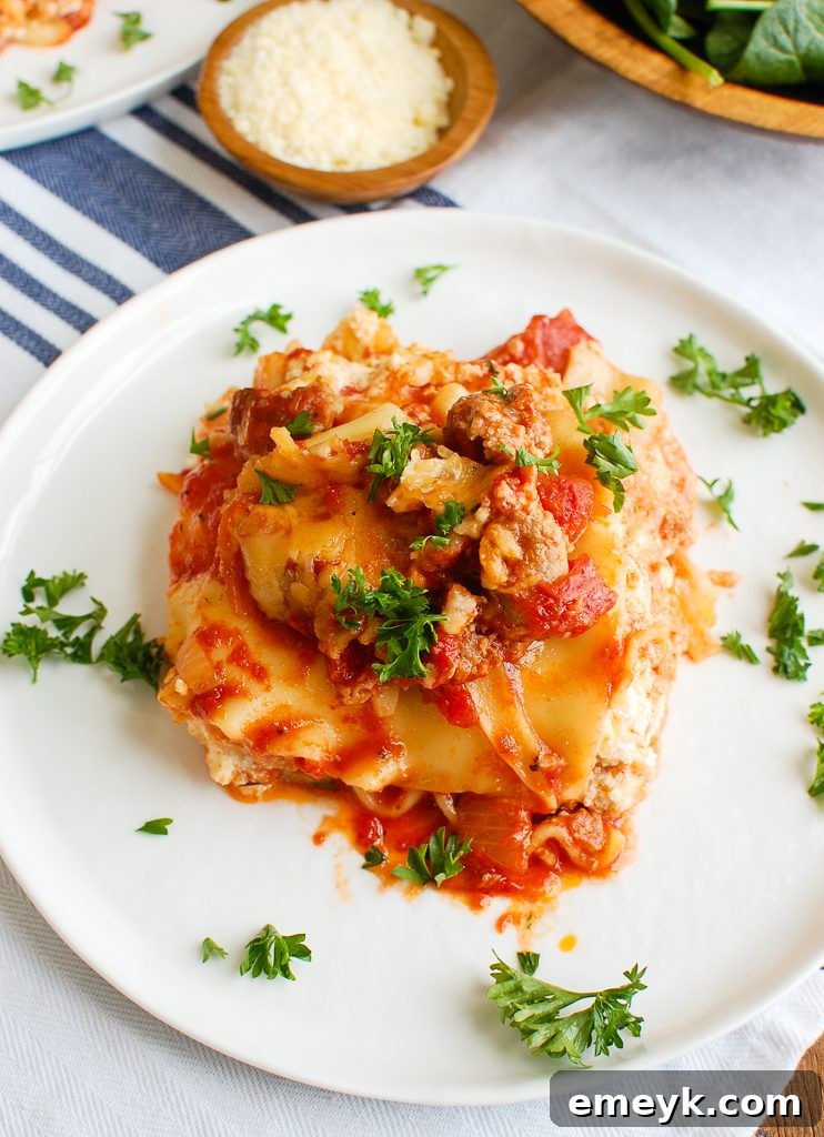 Close-up of Slow Cooker Lasagna garnished with fresh parsley and basil, ready to be served.