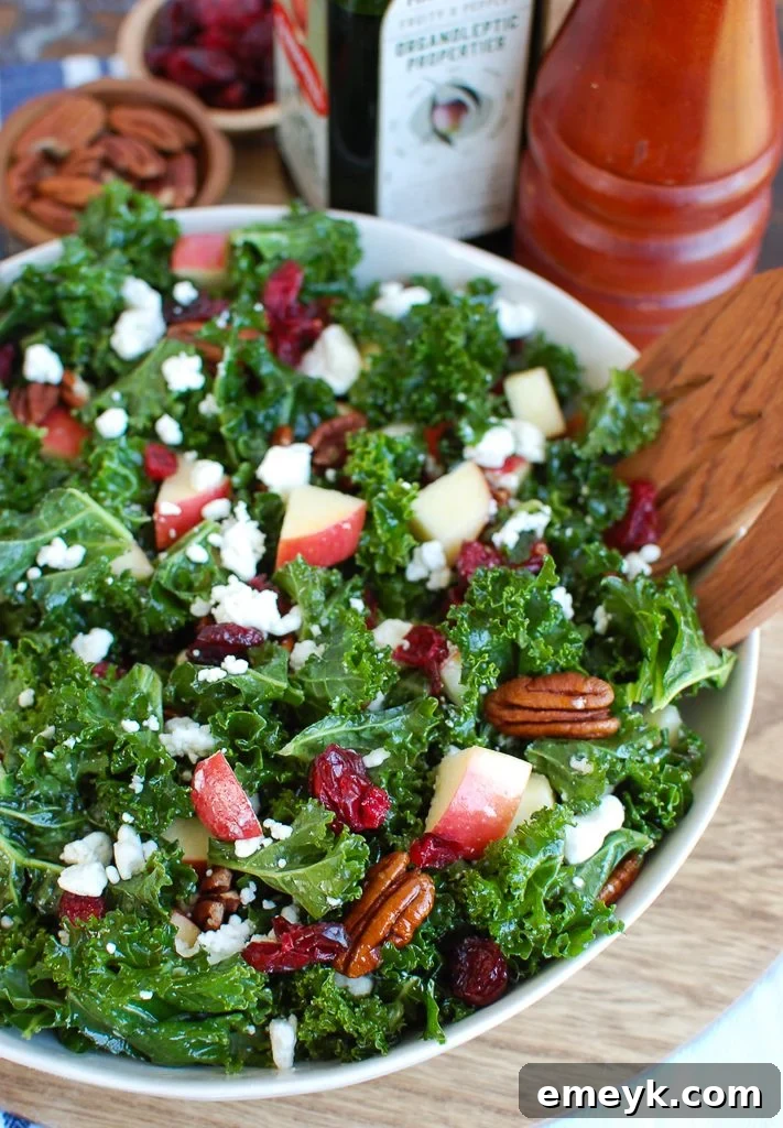 Kale Salad with Cranberries featuring freshly sliced apples and other vibrant ingredients