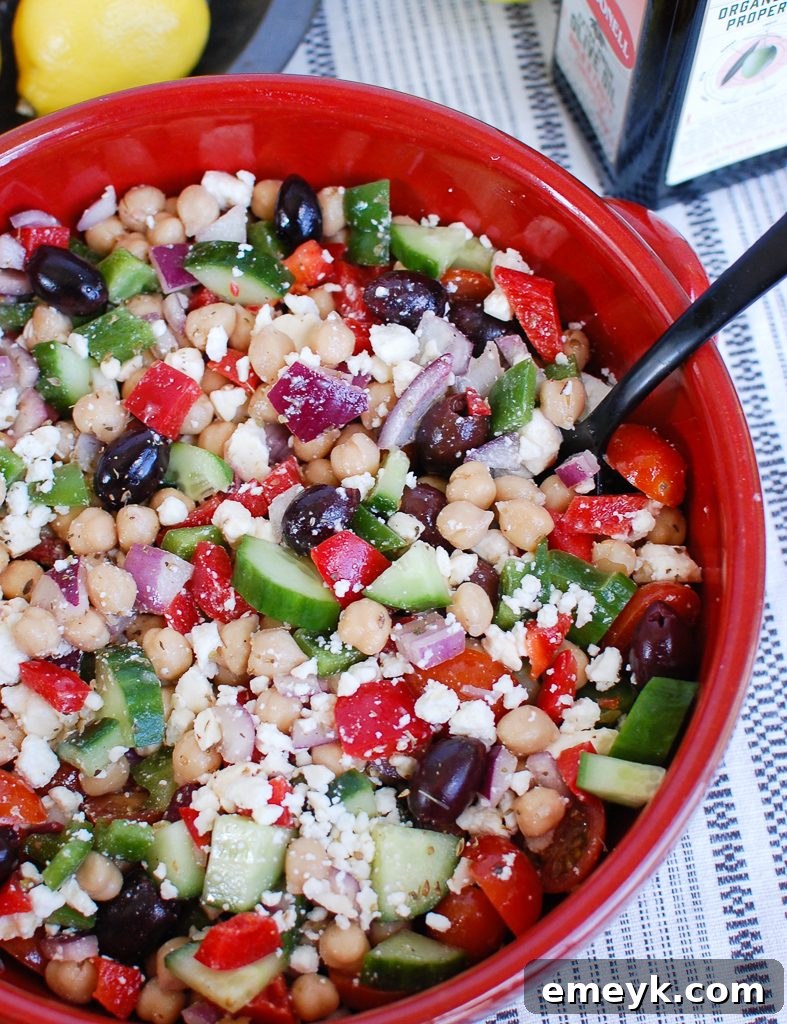 Vibrant Greek Chickpea Salad in a red bowl, ready to serve