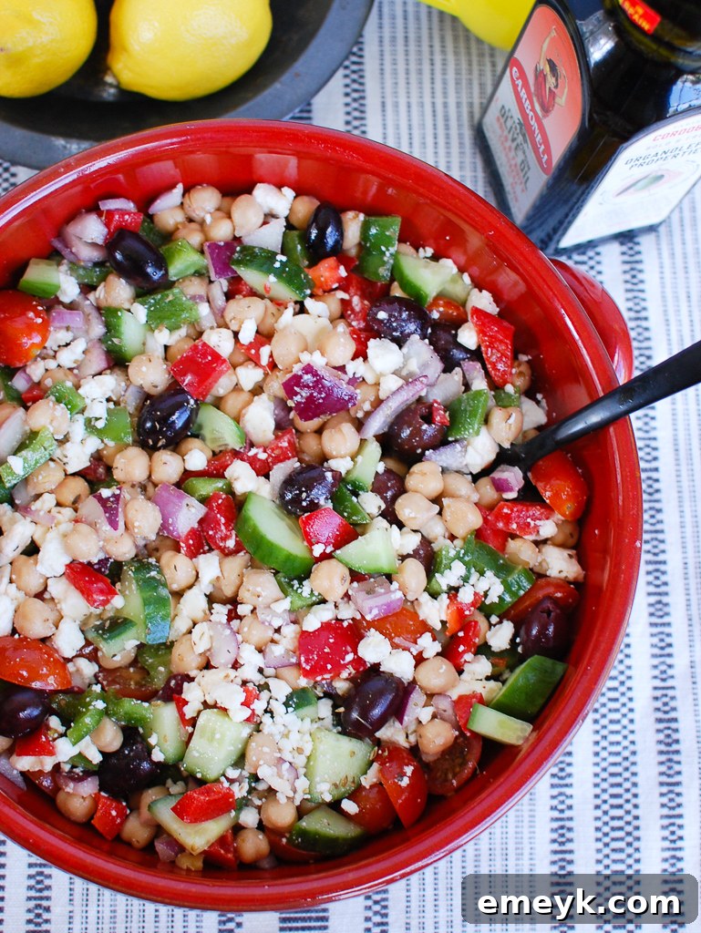 Close-up of Greek Chickpea Salad ingredients in a red bowl
