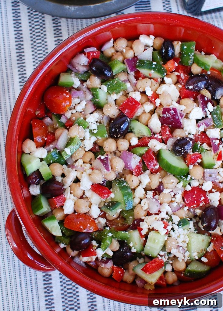 Generous serving of Greek Chickpea Salad in a large bowl, ready for customization
