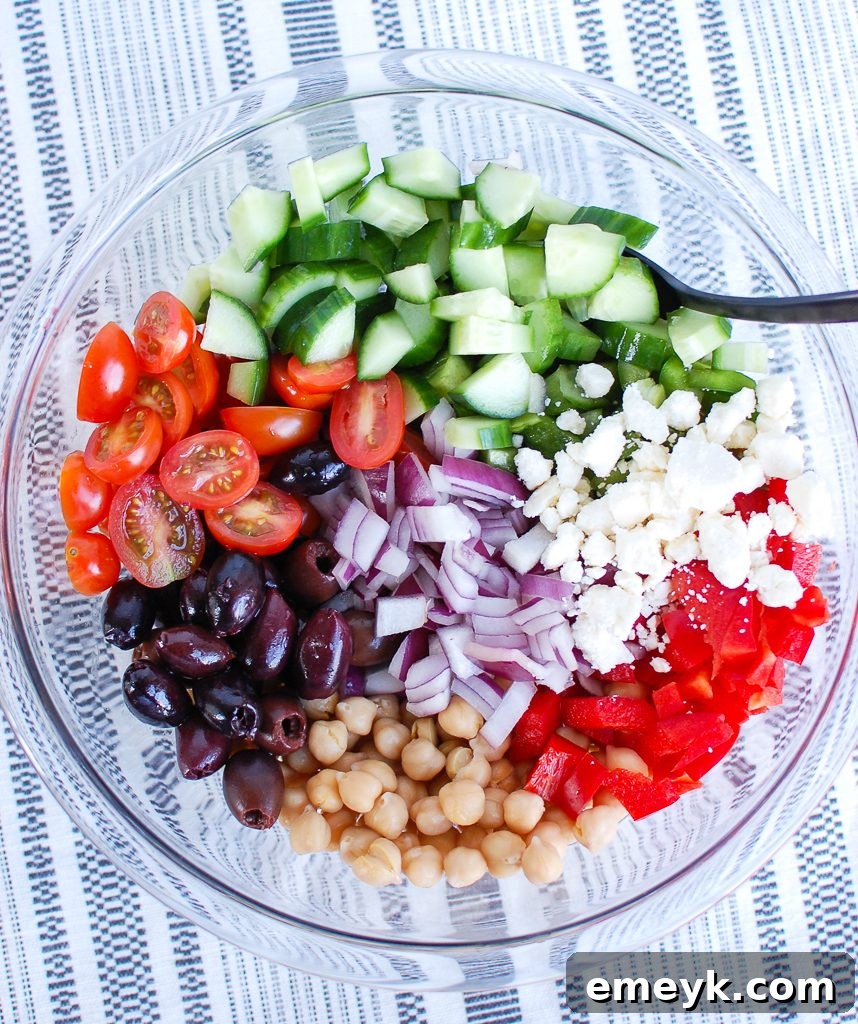 Fresh ingredients for Greek Chickpea Salad neatly arranged before mixing