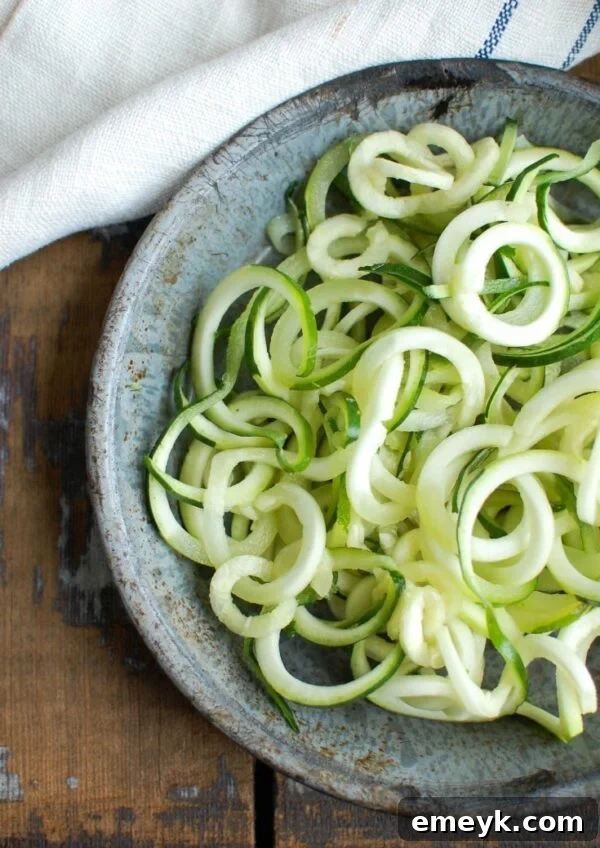 Spicy Asian Chicken Zoodle Soup is a lightened up version of your favorite Asian Chicken Noodle Soup using zucchini noodles. A spicy chicken broth is paired with chicken, carrots, fresh cilantro and green onions, Sriracha, lime juice and fresh ginger. This soups packs a lot of flavor into one bowl of soup.