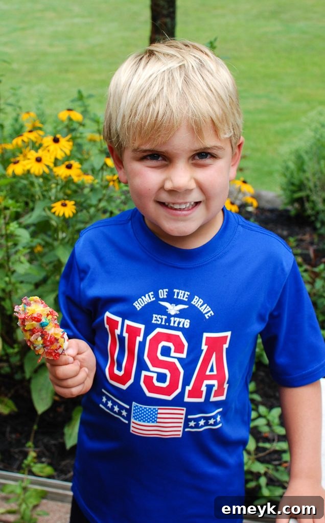 Child enjoying a Banana Crunch Popsicle outdoors on a sunny day