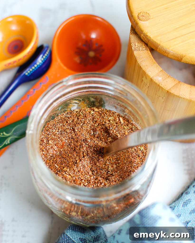 A jar filled with vibrant homemade taco seasoning, ready for use.