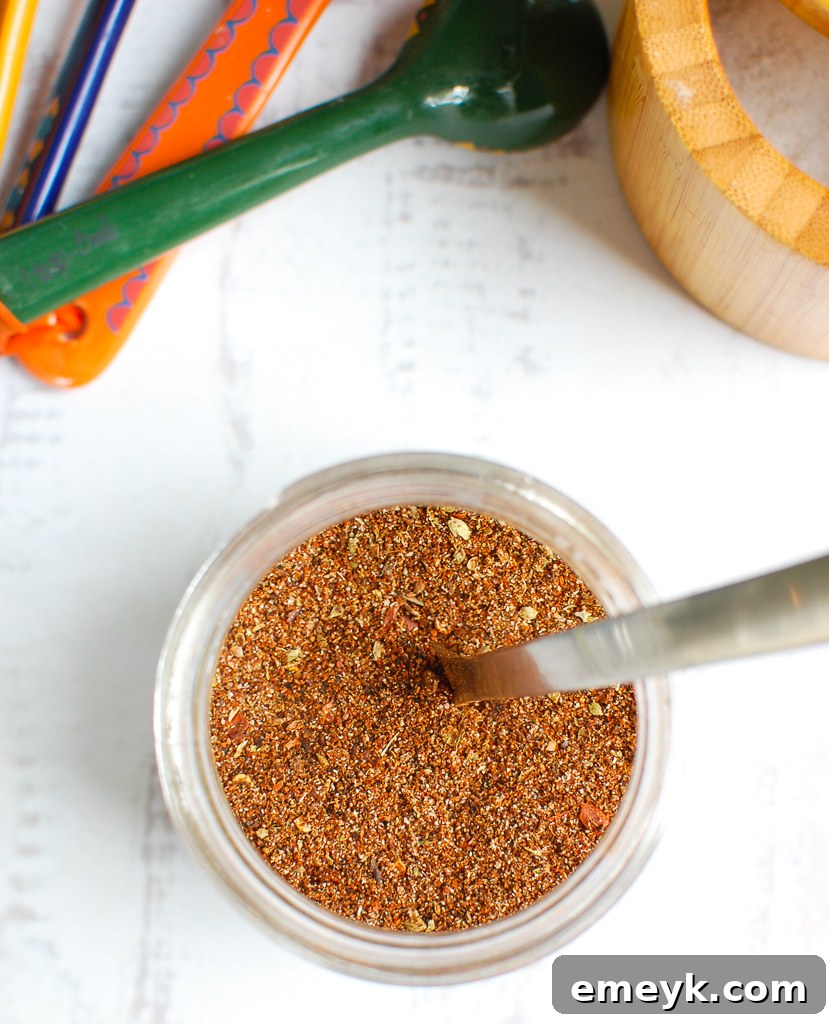 Homemade taco seasoning displayed with a spoon, ready to be used in cooking.