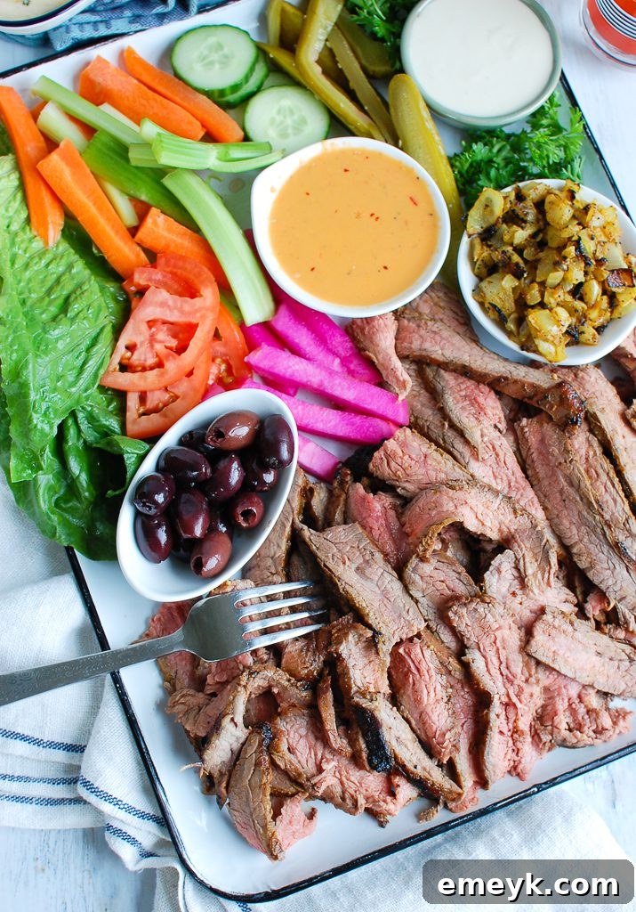 A platter of savory Beef Shawarma, garnished with fresh herbs and slices of lemon, hinting at its perfect pairing with tahini sauce.