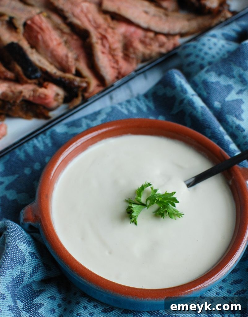 Grilled beef pieces artfully arranged with a generous serving of Tahini Sauce, illustrating a perfect culinary pairing.