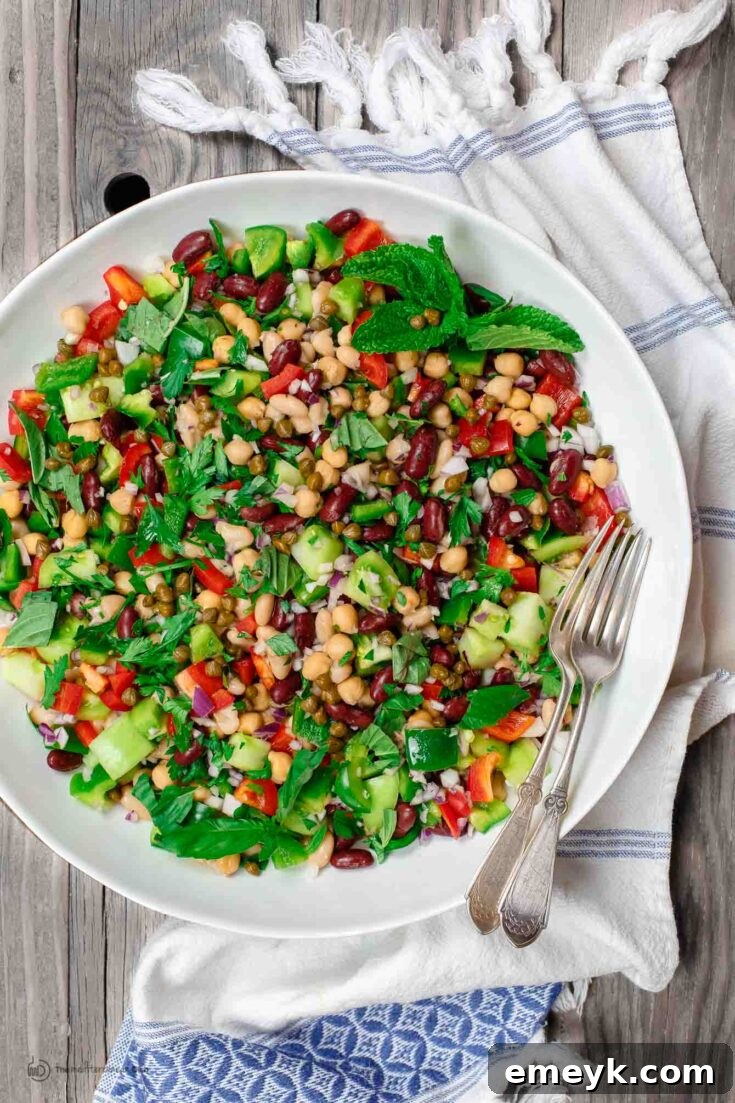 Flavorful Mediterranean Three Bean Salad with fresh herbs, capers, and a garlic Dijon vinaigrette