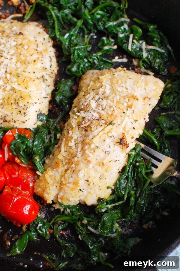Black Sea Bass Recipe with sautéed spinach and lemon wedges