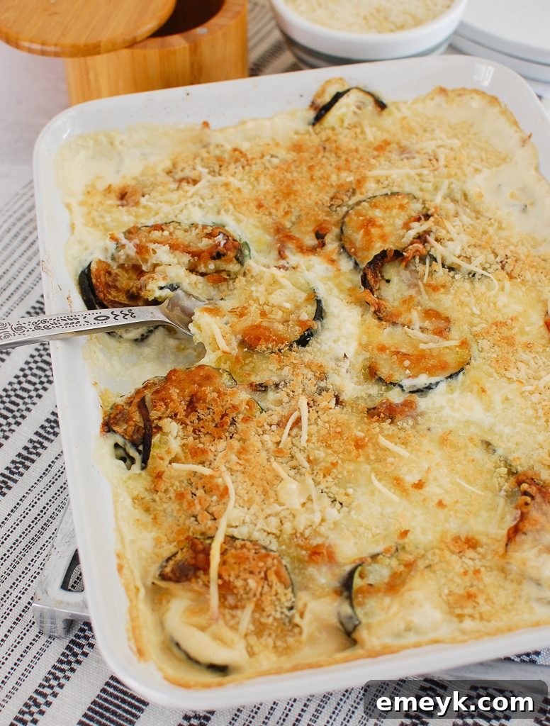 A full casserole dish of Zucchini Gratin, showcasing the rich texture and inviting golden top.