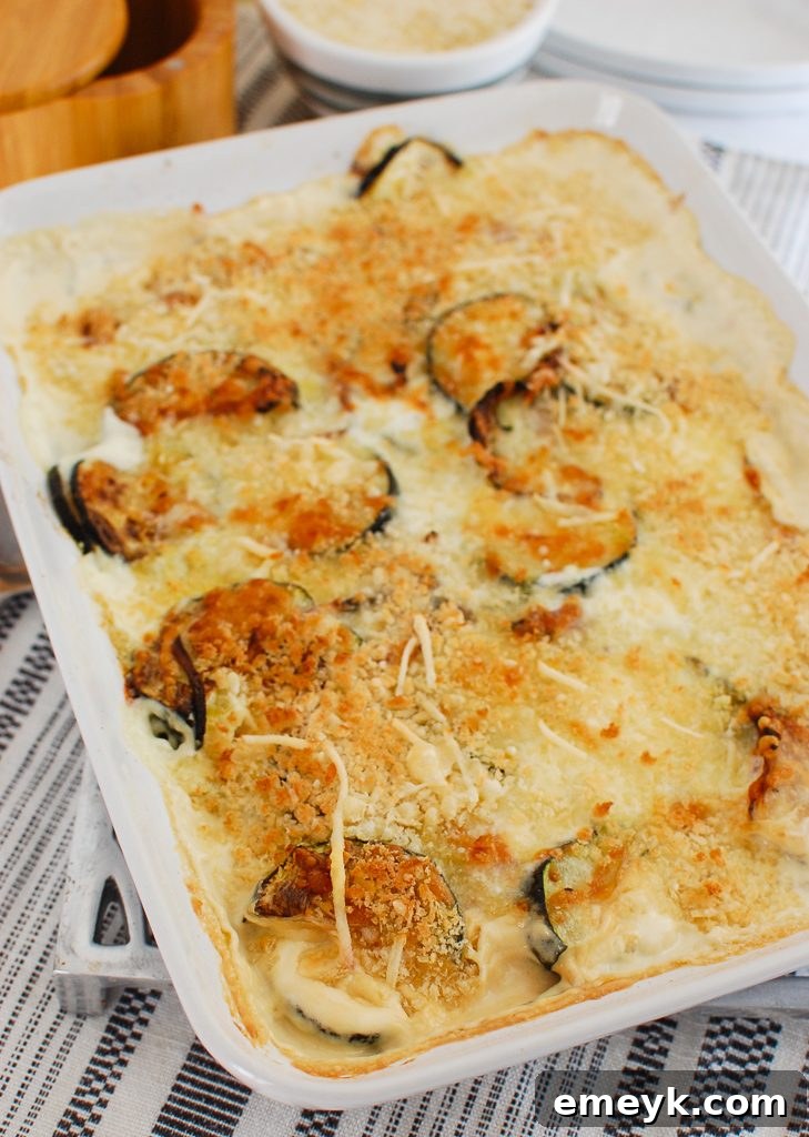 Freshly baked Zucchini Gratin in a white serving dish, piping hot and ready for the table.