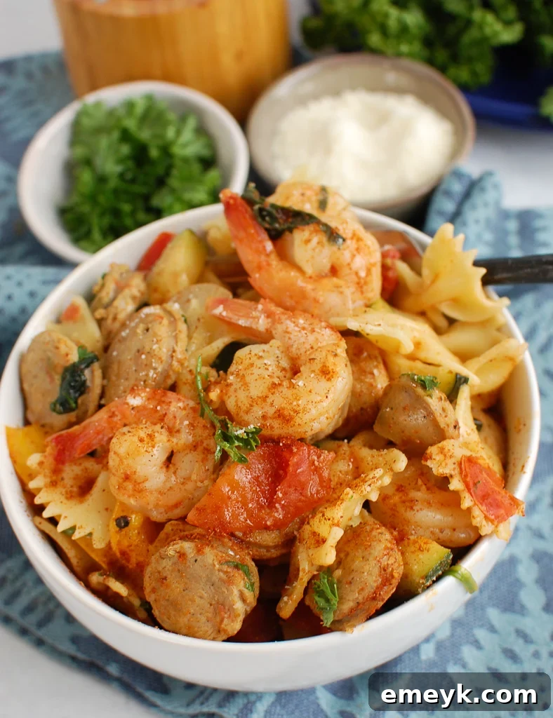 Bayou Blast Pasta with Chicken Sausage and Shrimp 2 Cajun Pasta with Shrimp and Chicken Sausage in a white bowl, garnished with parsley.