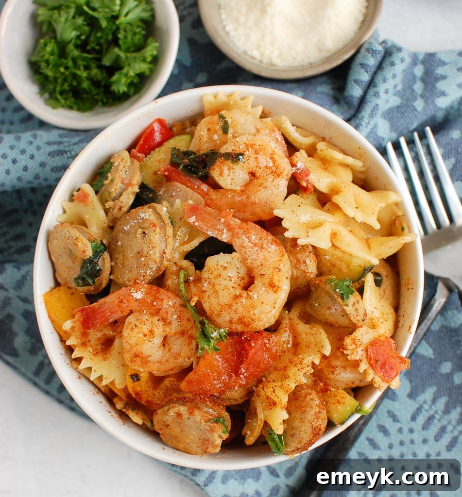 Bayou Blast Pasta with Chicken Sausage and Shrimp 4 A spoonful of creamy Cajun pasta with chicken sausage and shrimp, showcasing the rich sauce and fresh ingredients.
