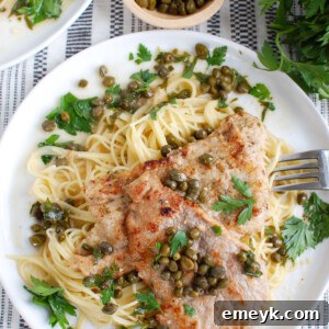 Veal Piccata on white plate, a close-up shot.