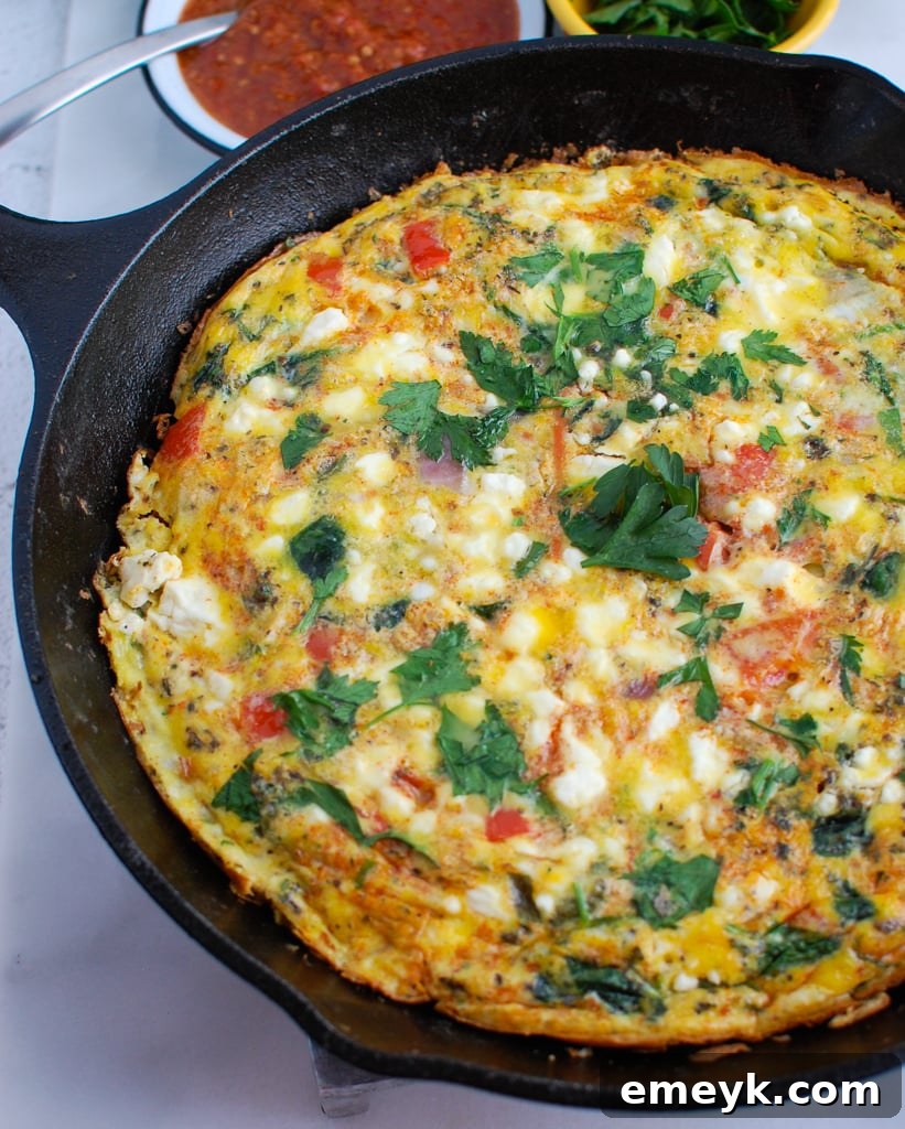 Mediterranean Frittata with a vibrant red harissa swirl, indicating its bold and aromatic flavor profile.