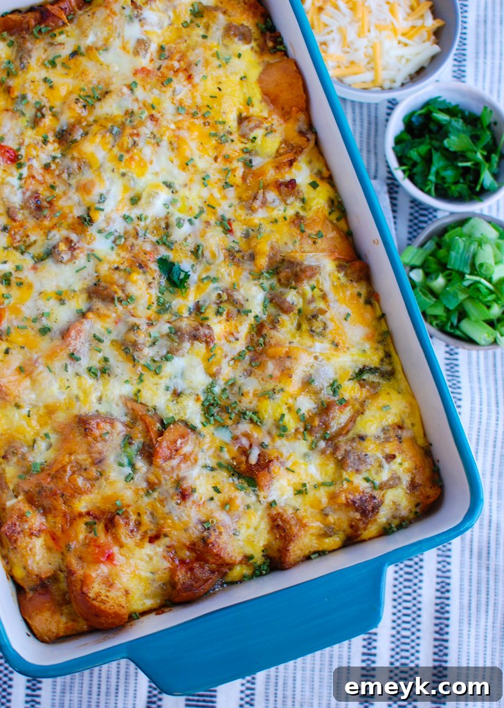 Freshly baked Egg Sausage Casserole served in a beautiful teal baking dish.