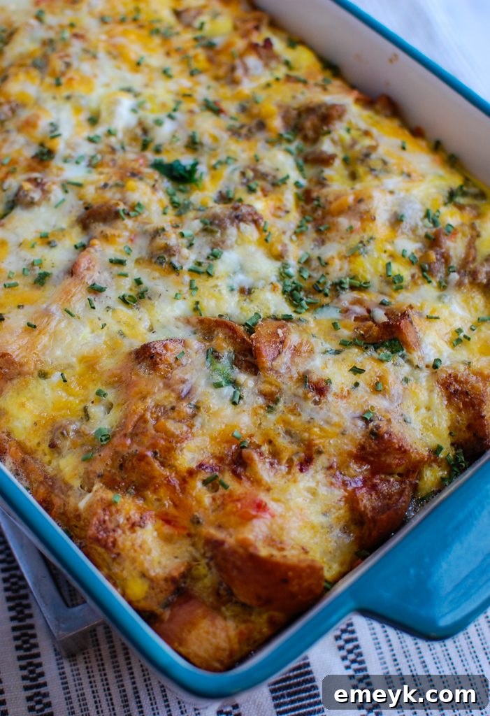 A slice of Egg Sausage Casserole being served from the pan with a spatula.