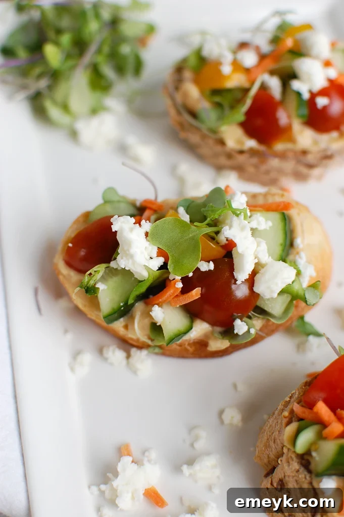 Individual Mediterranean Crostini pieces arranged neatly on a white plate, ready to be served.