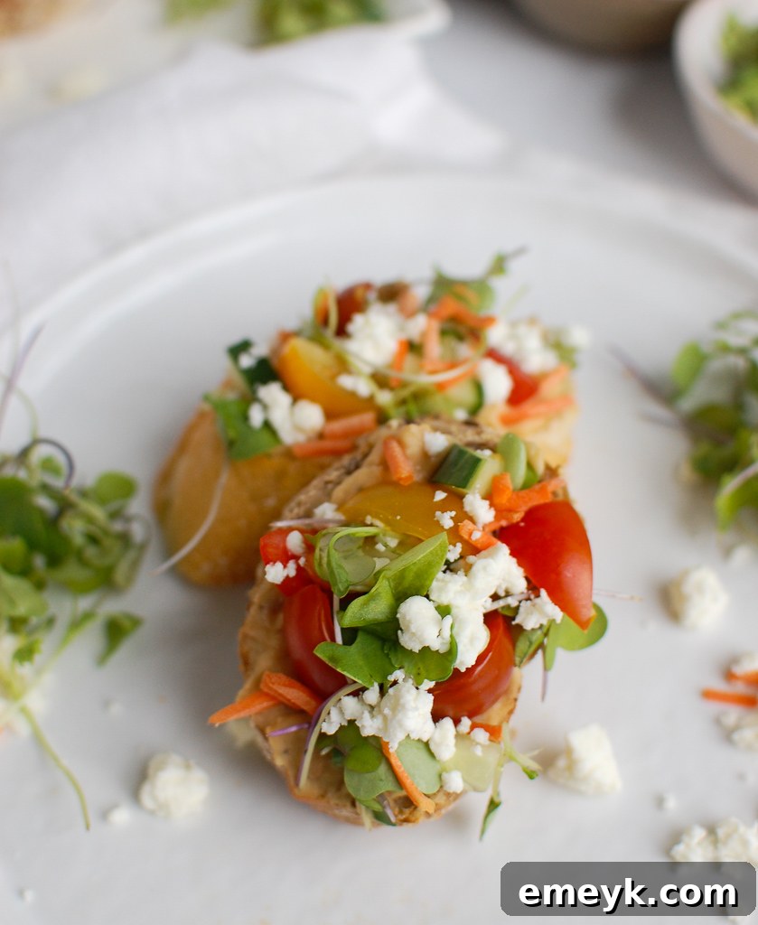 Two pieces of Mediterranean Crostini artfully arranged with various fresh toppings, ready for serving.