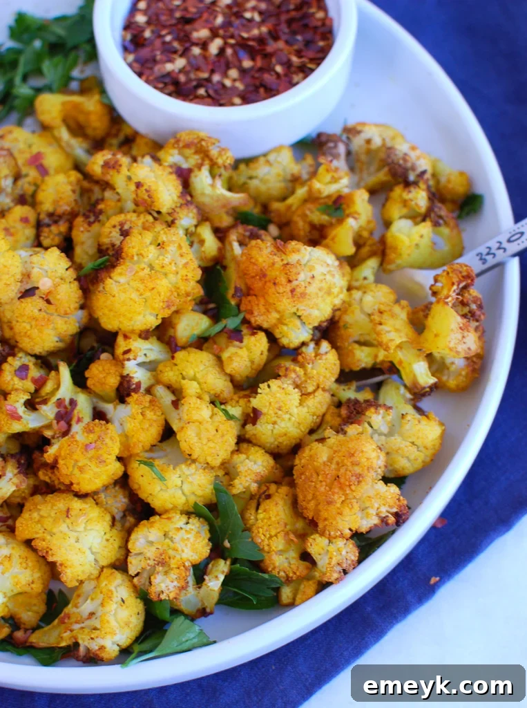 Perfectly Crispy Air-Fried Cauliflower 2 Crispy Air Fryer Cauliflower florets served on a white plate