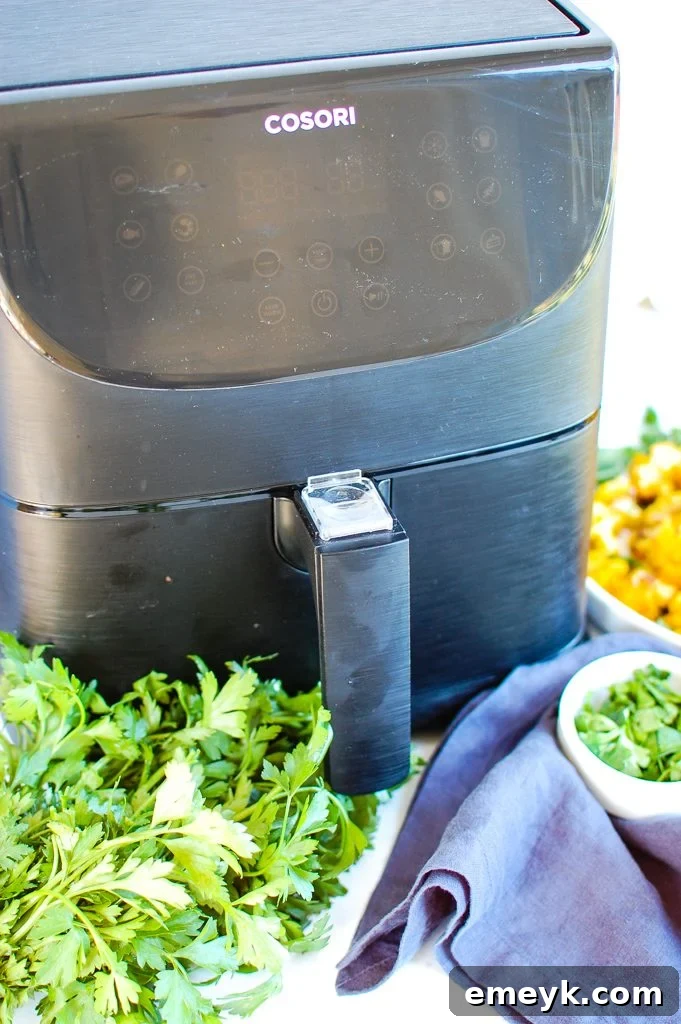 Perfectly Crispy Air-Fried Cauliflower 3 Air fryer basket filled with seasoned cauliflower florets, ready to cook