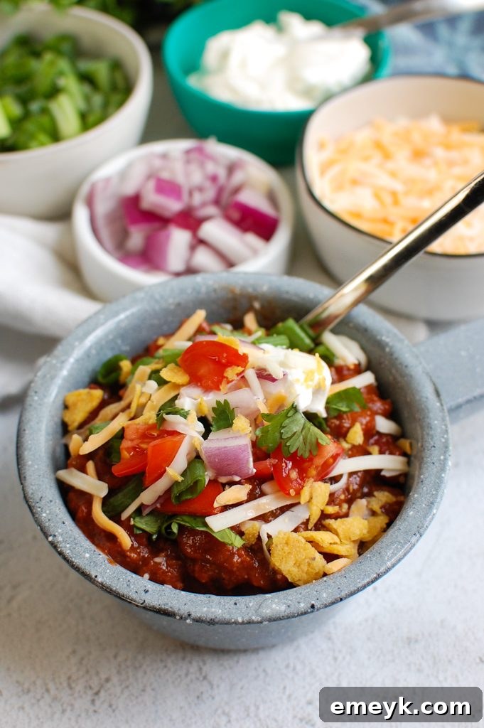 Hearty Classic Beef Chili served in a rustic blue bowl, garnished with fresh cilantro.
