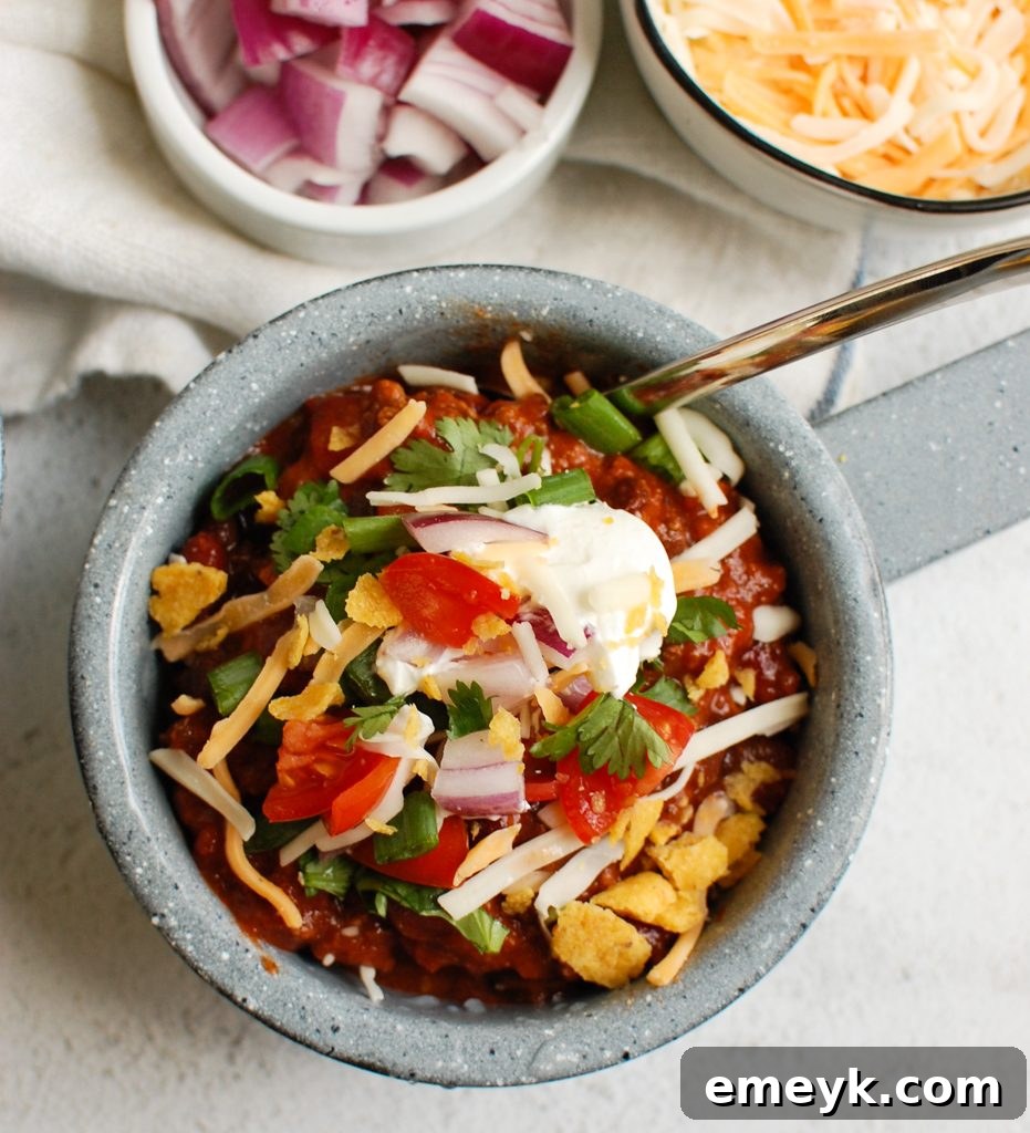 Close-up of Beef Chili in a bowl with a spoon, highlighting its rich texture and colors.