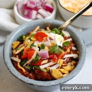 Classic Beef Chili Recipe in a white bowl with toppings