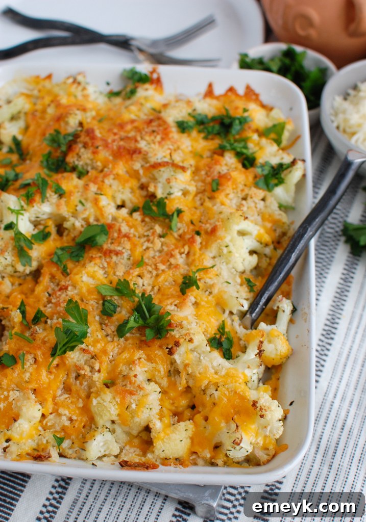 Cauliflower Gratin cooling in a white baking dish, showcasing its cheesy, golden-brown top.
