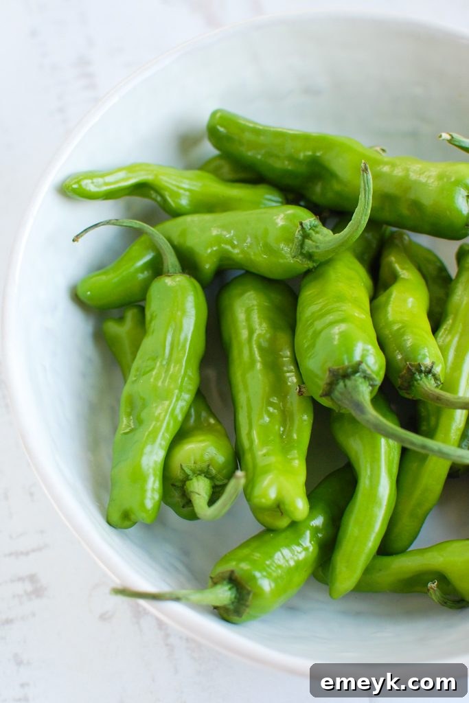 Sautéed Shishito Peppers with fresh lemon wedges, ready to serve