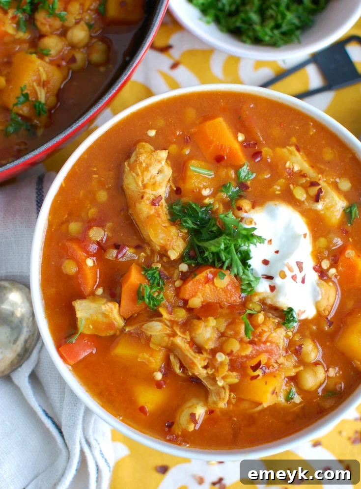Hearty Slow Cooker Moroccan Chicken Chickpea Soup, rich with spices and vegetables.