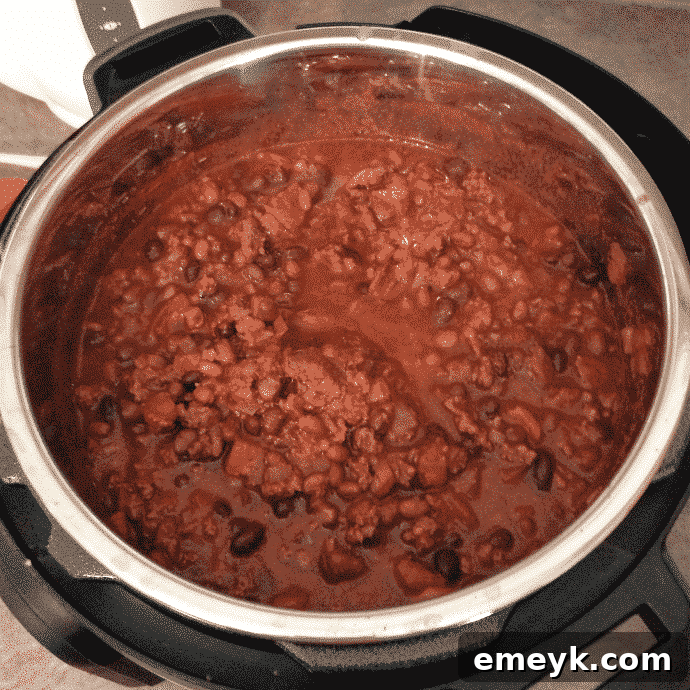 Award-winning Instant Pot Chili Con Carne in a bowl with corn and traditional toppings