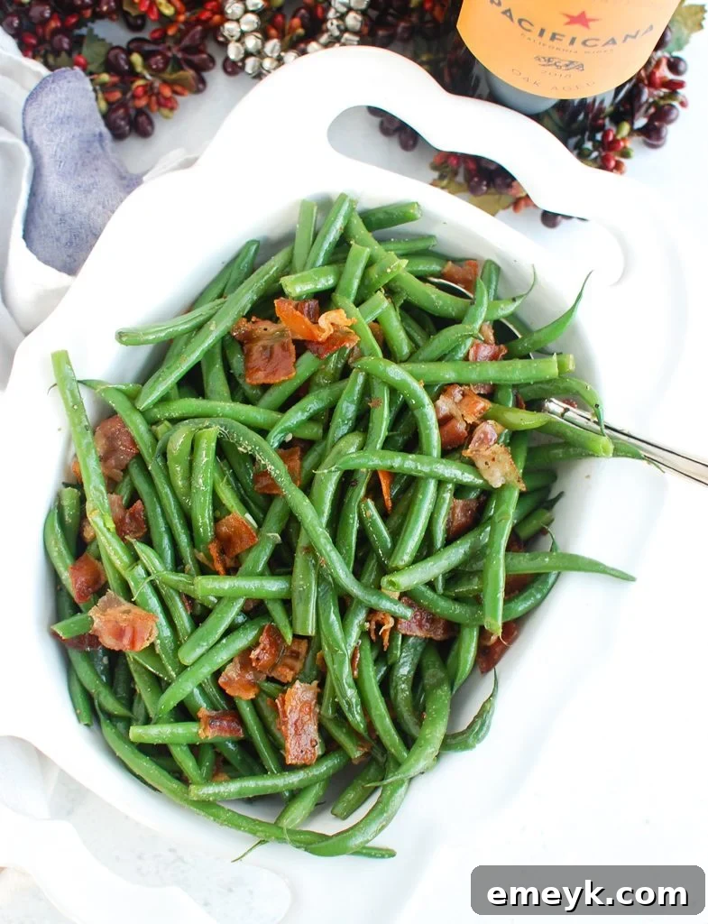 Green Beans with Bacon arranged artfully on a white plate with a napkin, ready for serving.