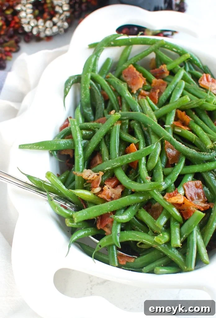 Green Beans with Bacon served in a bowl with a serving spoon.