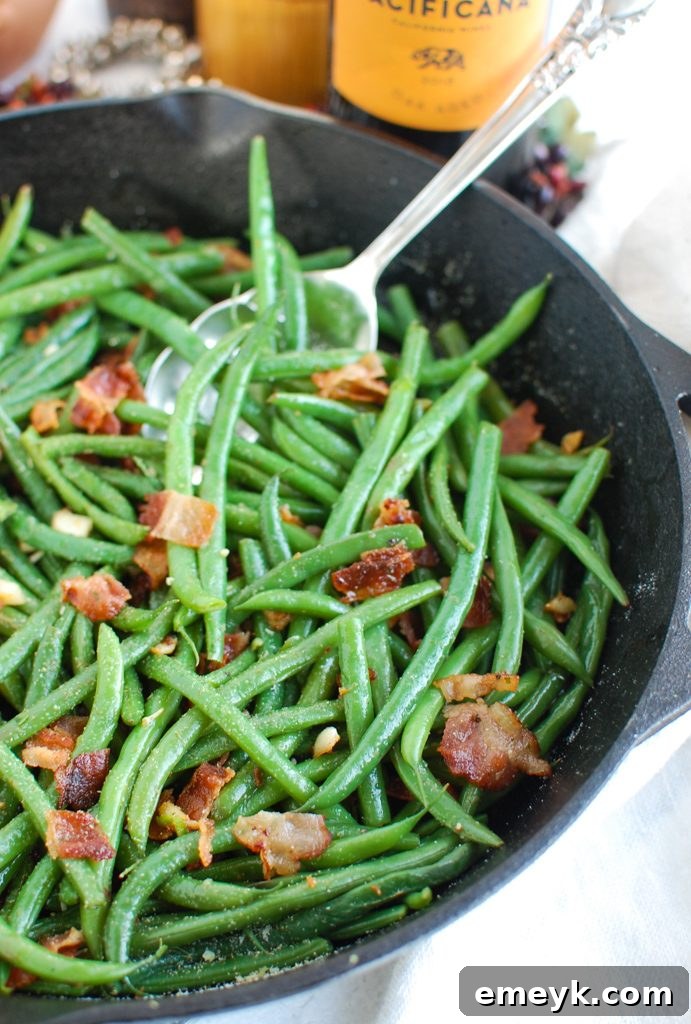 Green Beans with Bacon being tossed in a large skillet.