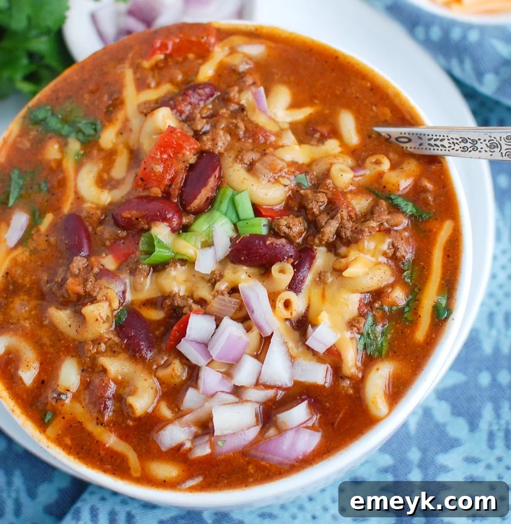 Instant Pot Chili Mac with a spoon, ready to be eaten